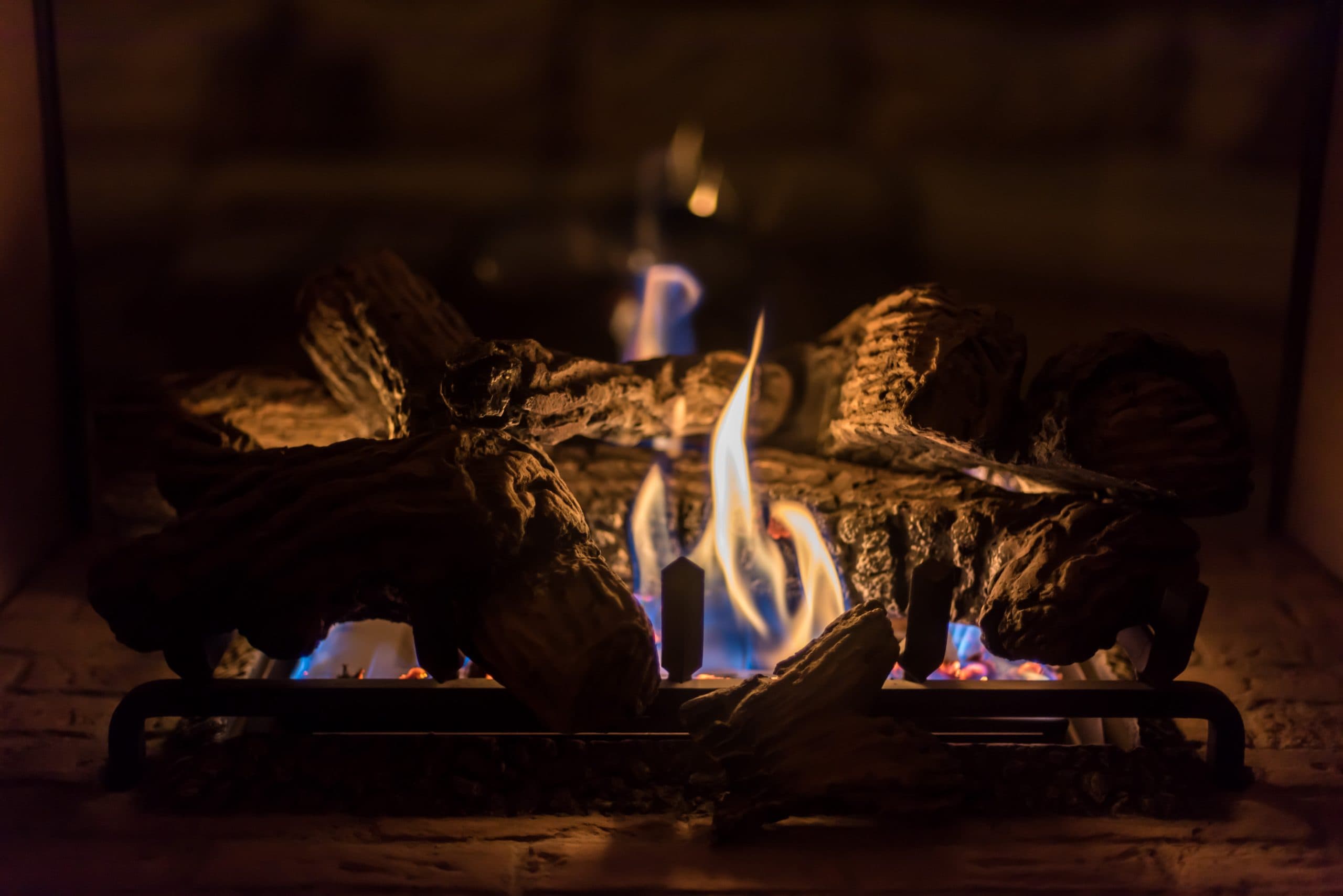 Ceramic logs alight in a gas fireplace