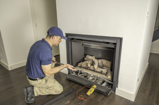 Technician working on a gas fireplace New Jersey